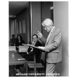 Hector Monro speaking at the launch of 'Don Juan in Australia'. Organiser Philip Martin seated centre