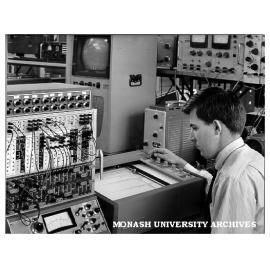 Researcher investigating size distribution of collection of particles using television scanning techniques