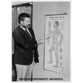 Honorary lecturer in Psychological Medicine Dr George Mendelson, with acupressure chart