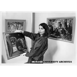 Acting Curator of Visual Arts gallery Elaine Merkus with paintings presented by Dr Clem and Mrs Nina Christensen