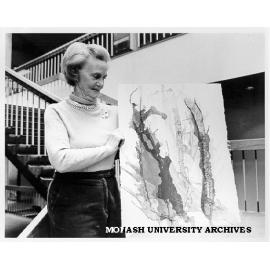 Artist Peggy Perrins Shaw with painting to be displayed in exhibition at Wiregrass Gallery