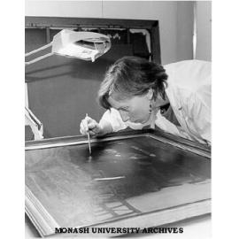 Conservator Robin Sloggert working on Percy Leason's 'The Artists Studio'