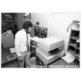 Systems programmer Ron Sawyer using laser printer in Computer Centre office
