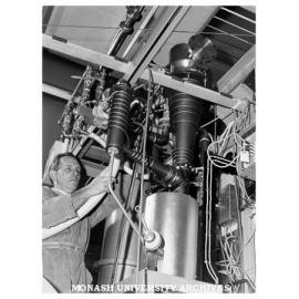 Senior technical officer working on pumping system of dilution refrigerator