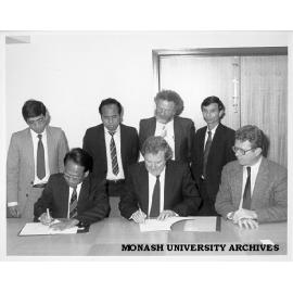 Signing of Memorandum of Understanding between Monash and University of Phnom Penh. from front left: Mr Ek Sam Ol, Professor Mal Logan, Dr David Chandler; rear: Mr Im Sethy, Mr Keou Soeun, A/Prof. Leo West, Mr Pit Chamnan