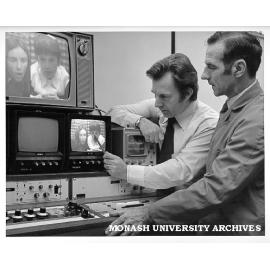 Dr Terry Hore (left) and HEARU technical officer Ron Crossley studying split-screen video of teacher-pupil behaviour