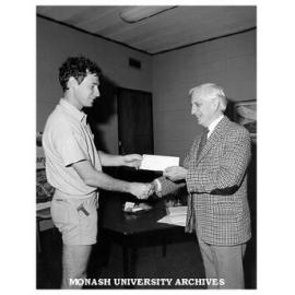 Director Peter Thompson accepting Garnet H. Carroll award from Professor John Legge