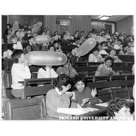 Third year medical students blowing-up condoms