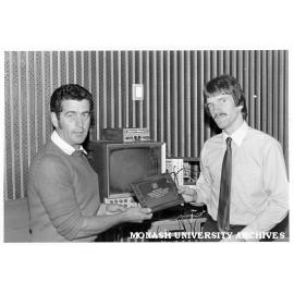 Nick Batten (right) receiving IREE trophy from Dr Barry Harrison, chairman of Melbourne division, for best final year electrical engineering project