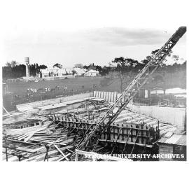 Science lecture theatres under construction, Talbot Colony buildings in background with standing water tower.