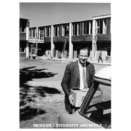 Professor W. A. G. Scott unloading car outside Science buildings