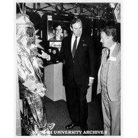 Sir Brian Murray examining Drager Proximity Suit on display at Occupational Health and Safety Convention