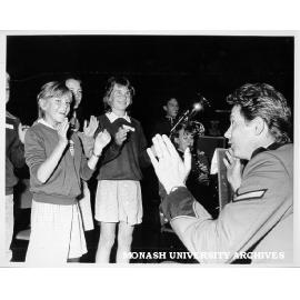 Member of the Third Military District band with local school children