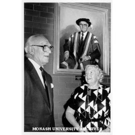 Sir Louis Matheson and Lady Matheson under Patricia Moran portrait commissioned by staff members