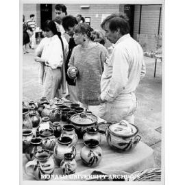 Browsers at pottery stall outside Union building