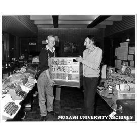 Earl Headland (right) and Tim McNair arranging goods for 'garage sale' of used equipment
