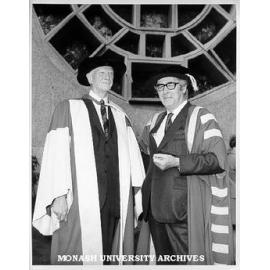 Honorary Doctor of Laws Sir Lindesay Clark with newly installed Chancellor Sir Richard Eggleston, in front of Lindesay Clark window by Leonard French, Robert Blackwood Hall