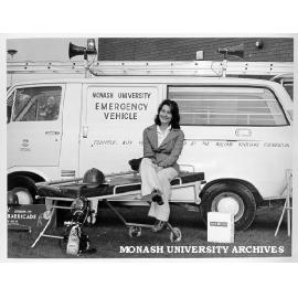 Student Julie Roberts in front of emergency vehicle