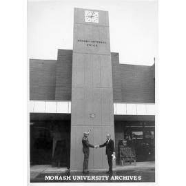 Warden Mr Graeme Sweeney (right) thanking President of Friends of Monash for the Union clock