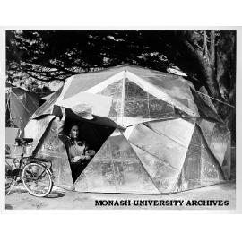 Economics student Laurel Ceff emerging from geodesic dome used for Pushbike Club camping trips