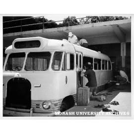 Greg Segal (at door) and John Green (on roof) restoring Union bus