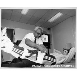 Dr Jayaram from St John's Ambulance demonstrating first aid technique on gardener Paul Mechelen