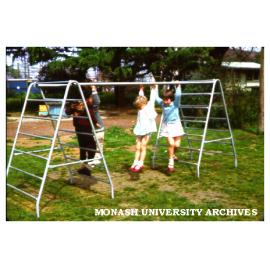 Children playing on climbing bars at Birch Cottage