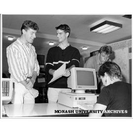 Host Scheme enrolment. Coordinator Harvey Kalman (centre) and volunteer helper Wendy Bainger (seated) enrolling Gregory Young (left) and Peter Smith