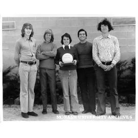 Volleyball team with trophy, from left: Mark Troliniuk, Ray Wilson, Liz Minahan, Steve Trafficante and George Szlawski