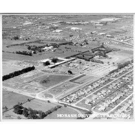 Aerial view of Science buildings under construction, March 1961, from north-west, with Wellington and Dandenong roads in background