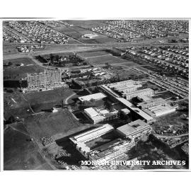 Aerial view of building construction, July 1962, from north with Engineering in foreground and intersection of Wellington and Dandenong roads in background