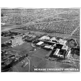 Aerial view of building construction, July 1962, from east, with Clayton in background