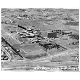 Aerial view of buildings, January 1963, from south west with intersection of Wellington and Dandenong roads in foreground