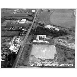 Aerial view of halls site, December 1963, from north with sports oval and drive-in in background