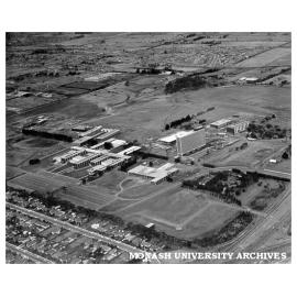 Aerial view of site and buildings, January 1964, from south west with intersection of Wellington and Dandenong roads in foreground