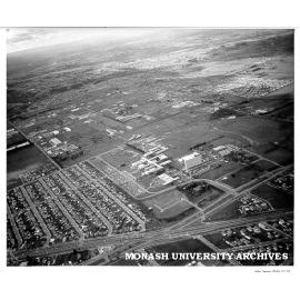 Aerial view of site and buildings, July 1964, from south west with Dandenong Road and Clayton suburbs in foreground