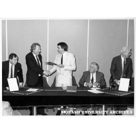 Signing of Heads of Agreement between Monash and Chisholm Institute of Technology, Vice-Chancellor Professor Mal Logan and President of Chisholm Council Mr Paul Ramler shaking hands