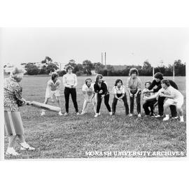 Women's cricket team with coach Lola Cameron
