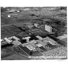 Aerial view of site and buildings, August 1963, from north west with drive-in in background