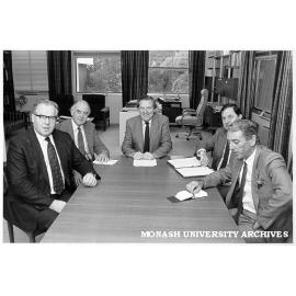 Meeting in Vice-Chancellor's Office. Vice-Chancellor Professor Mal Logan (centre), Sir Peter Swinnerton-Dyer (left, UK University Grants Commission), DVC Professor Ian Polmear, Comptroller Mr Peter Wade, and Registrar Mr Tony Pritchard
