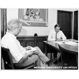 Portraitist Brian Dunlop (left) working on portrait of Professor Ray Martin