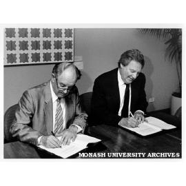 Mr Harry Wragge of Telecom and Professor Mal Logan signing memorandum of understanding to fund Centre for Communications and Information Engineering