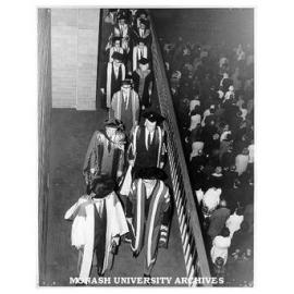 Academic procession leaving Robert Blackwood Hall after opening ceremony