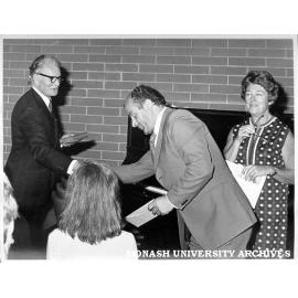 Award of certificates for English language intensive course. Mrs Hedy Hurst, senior tutor in German (right) , Assistant Commonwealth Director of Immigration for Victoria Mr D. S. Waddell (left)