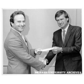 SEC Manager presenting cheque for students system development to Jack Greig