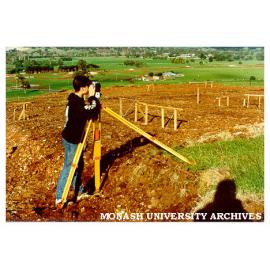 Field work student using surveying equipment