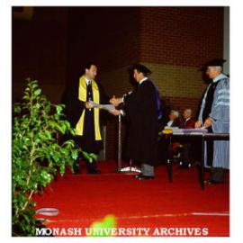 Police Studies graduate Robert Hastings receiving Associate Diploma from President of Council Dr Lionel Ward