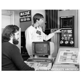 Engineering students, John Simmons (left) and Bruce Olsson, demonstrating CAD-CAM link