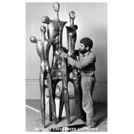 Mr Cole Sopov, Head of Chisholm Sculpture department, with sculpture 'Family of Man'