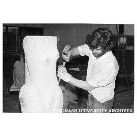 Sculptor Michael Cartwright carving torso from sandstone block donated by Ripponlea